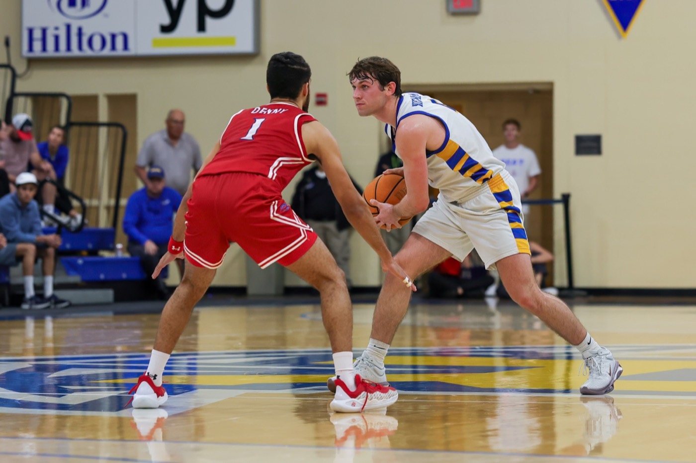 Michael Niemann handling the ball against a defender for Rollins College