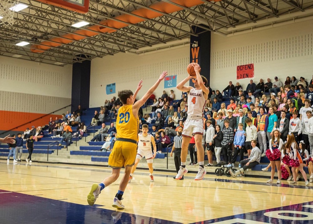 Michael Niemann taking a jump shot in a Wakeland High School game